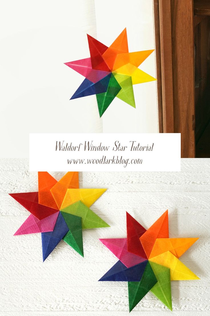 three colorful paper stars are hanging on the wall