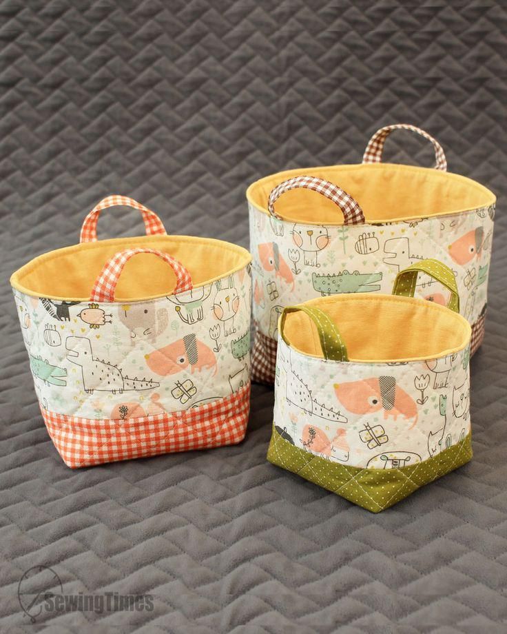 three fabric storage baskets sitting on top of a bed