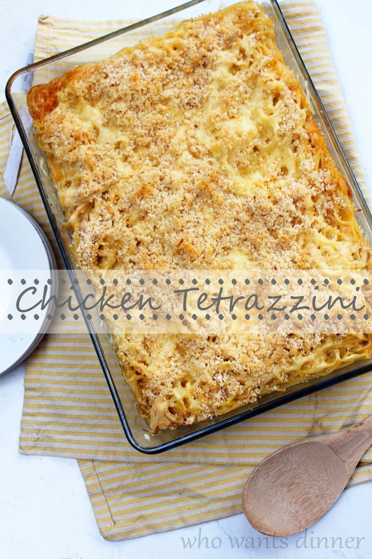 a casserole dish is sitting on a napkin next to a bowl and spoon