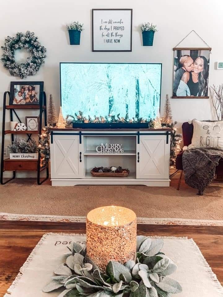 a living room filled with furniture and christmas decorations on top of a wooden coffee table