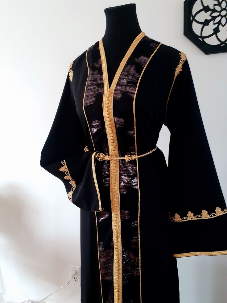 Top quality black Moroccan kaftan, in silk crepe, sfifa and Tlija. This caftan is ideal for family occasions such as family celebrations, the month of Ramadan, Aid, or weddings. Several sizes available. Please contact us for more information. Top quality black caftan, in silk crepe. This caftan is ideal for family occasions such as family celebrations, the month of Ramadan, aid, or weddings. Several sizes available. Contact us for more information. Black Long Sleeve Kaftan For Eid, Traditional Long Black Kaftan, Black Ceremonial Kaftan For Eid, Black Traditional Drape Dress For Ceremonies, Black Dress For Traditional Ceremonies With Traditional Drape, Traditional Formal Kaftan For Festivals, Traditional Kaftan With Kimono Sleeves For Party, Elegant Kaftan With Kimono Sleeves For Holidays, Elegant Festive Kaftan With Kimono Sleeves