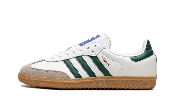 The adidas Samba OG "Collegiate Green" is a colorway of the retro shoe with green accents.  The upper features a white leather base contrasted with a grey suede overlay on the toe, and a green leather panel on the heel tab.  Collegiate Green leather Three Stripes appear on the sides, while a gold foil “Samba” logo can be seen on the lateral side of the mid-panel.  Classic adidas Samba detailing is printed on the tongue.  A gum rubber sole completes the look. Adidas Sst Green, Luxury Green Skate Shoes Sporty Style, Luxury Green Skate Shoes In Sporty Style, Samba Green Stripes, Adidas Samba Green, Adidas Shoes Samba, Informational Poster, Adidas Samba Og White, Adidas Campus 80s