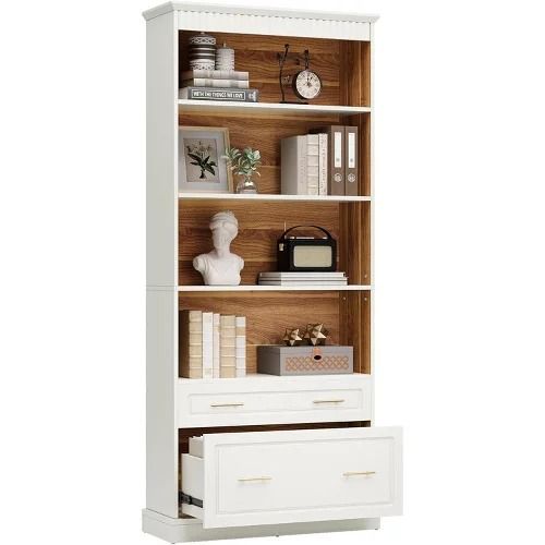 a white bookcase with drawers and books