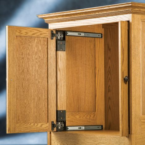 a wooden cabinet with metal latches on the front and side doors, in a room