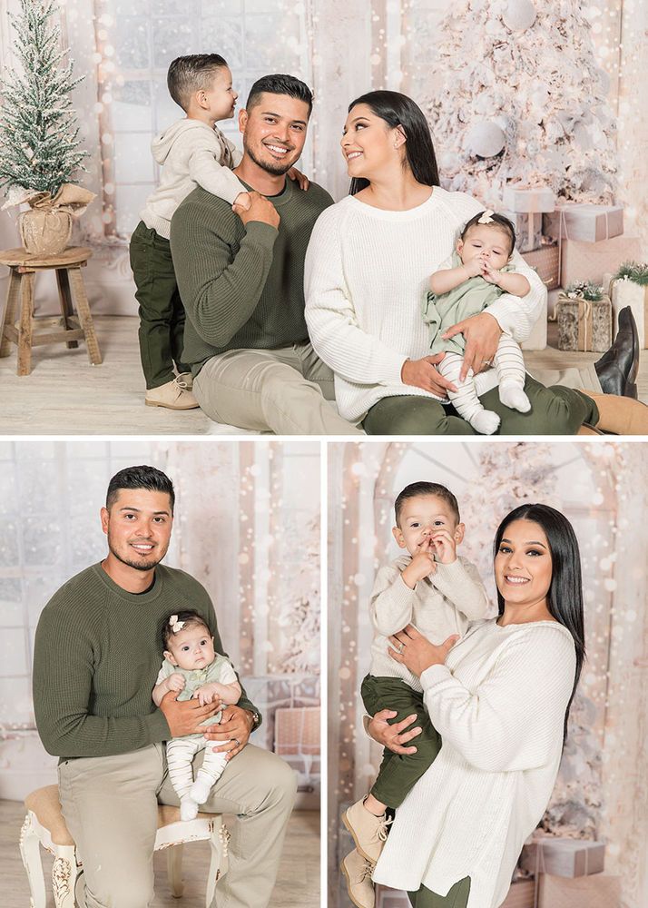 a man and woman holding their baby in front of a christmas tree