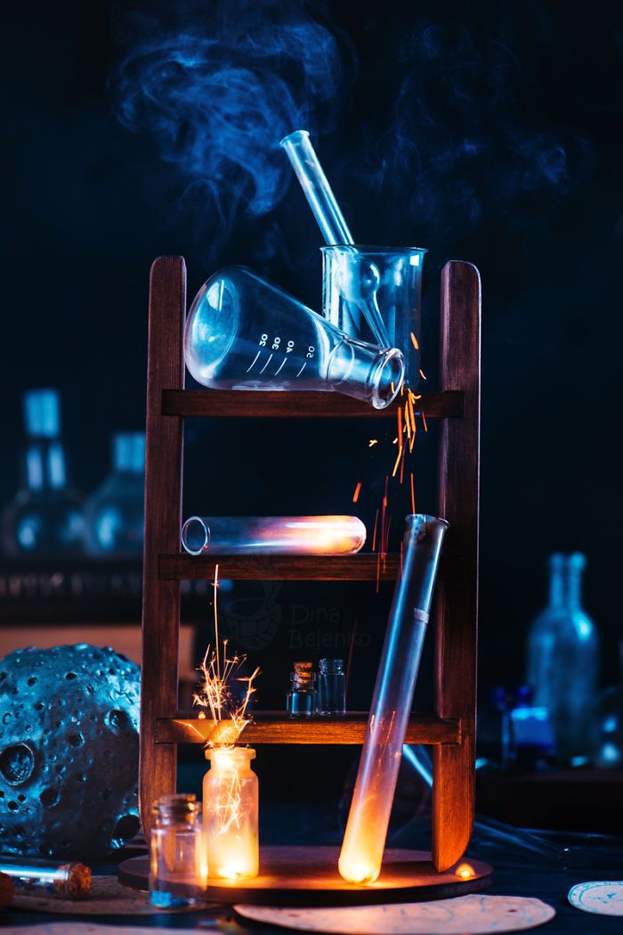 a wooden shelf with bottles and candles on it in the middle of a room filled with other items