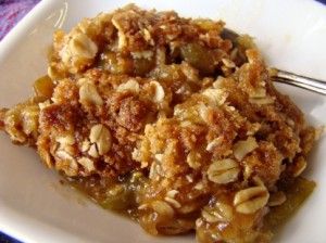 a white plate topped with fruit and oatmeal crumbled toppings