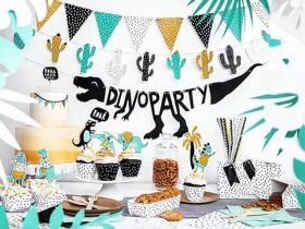 a dinosaur themed birthday party with desserts and decorations