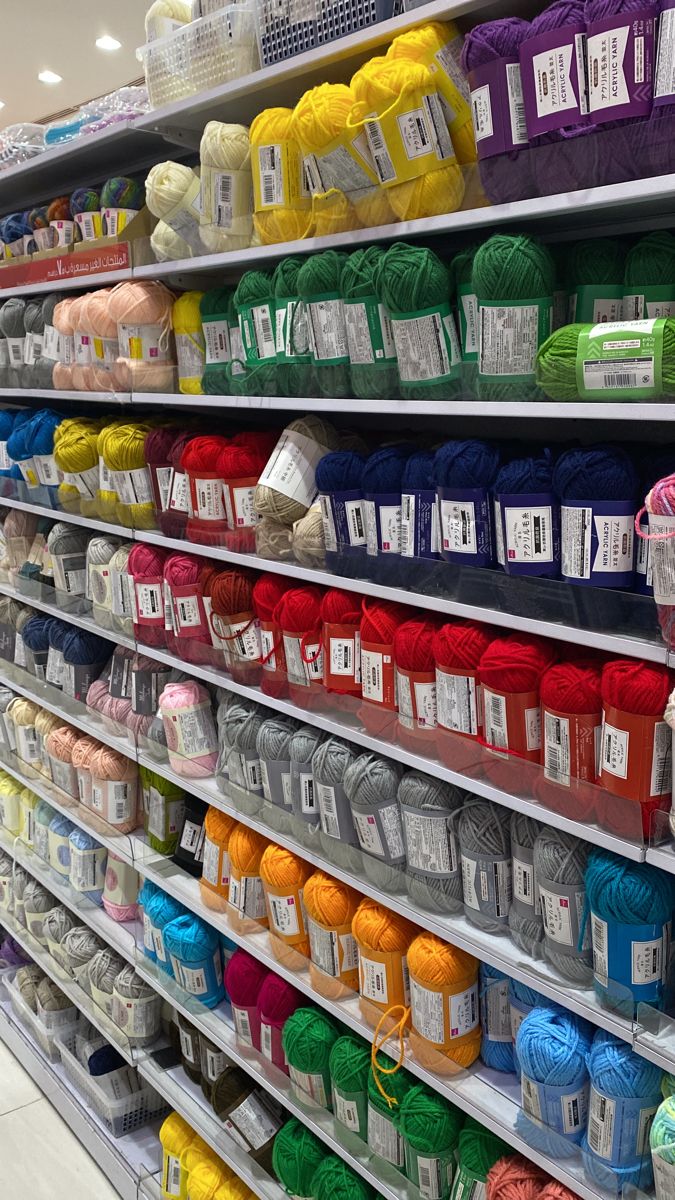 the shelves are full of yarn and crochet items for sale in a store