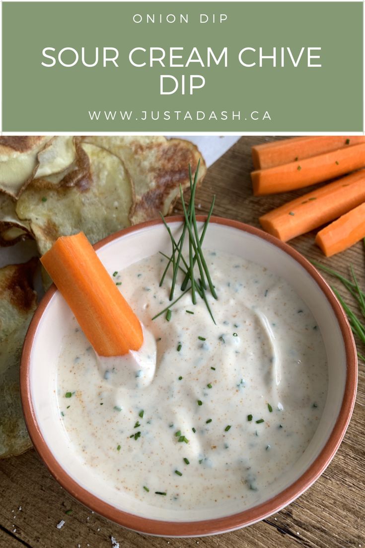 a bowl of ranch dip with carrots and pita bread on the side next to it