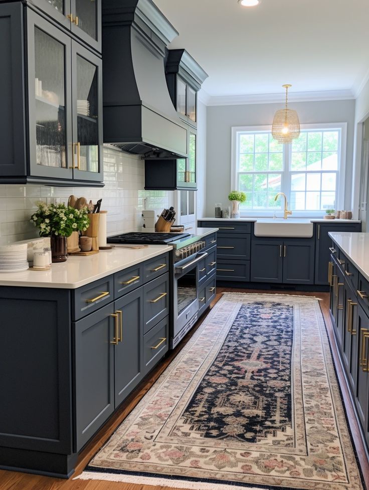 a kitchen with blue cabinets and an area rug on the floor in front of it