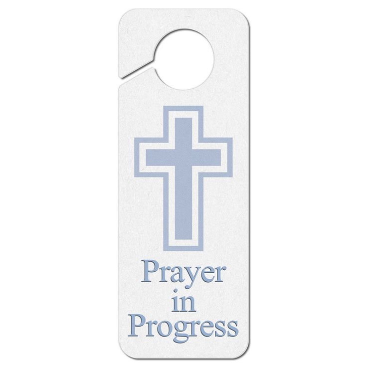 a white door hanger with the words prayer in progress on it and a blue cross