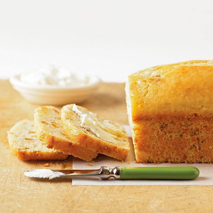 a loaf of bread sitting on top of a cutting board next to butter and a knife