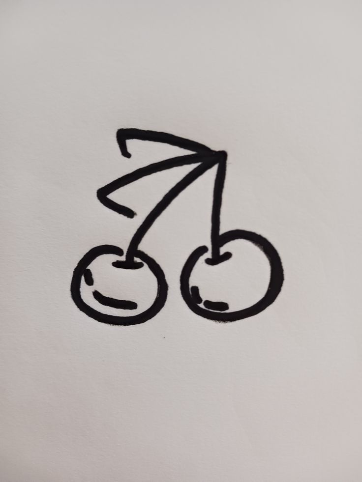 a drawing of a bicycle on a white paper with black marker marks in the middle