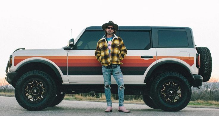 a man standing in front of a truck