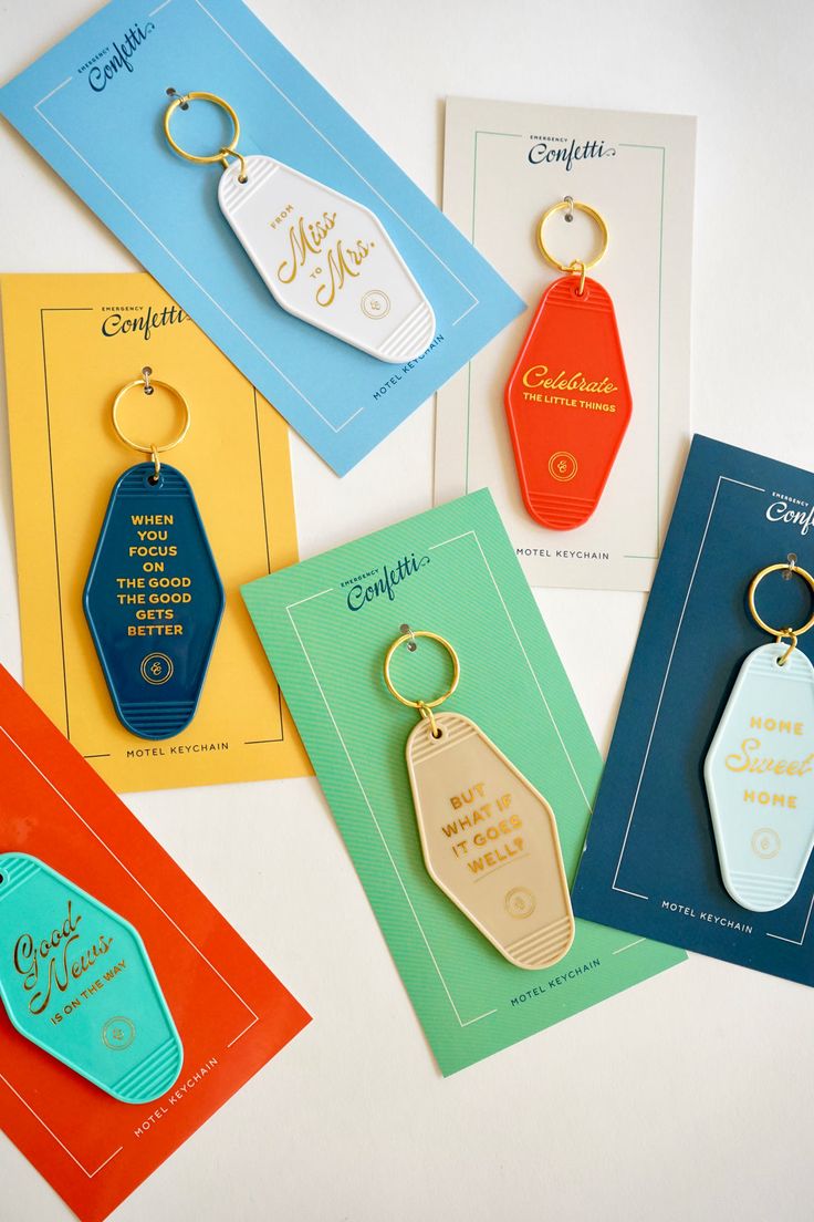 Celebrate the Little Things Keychain – Emergency Confetti Motel Keychain Packaging, Keychain Packaging Design, Unique Merch Ideas, Vintage Motel Keychain, Hotel Key Card Design, Hotel Keychain Ideas, Hotel Keychain Design, Key Ring Ideas, Keyring Packaging