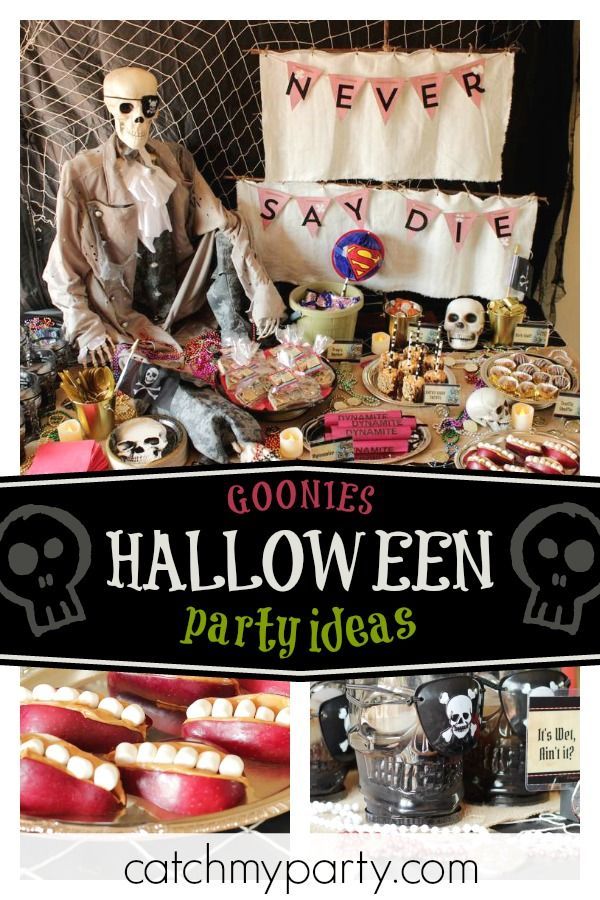 a halloween party with lots of decorations and treats on the table, including fake skeletons