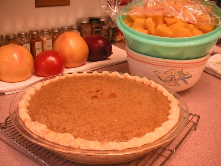 a pie sitting on top of a counter next to other foods and condiments