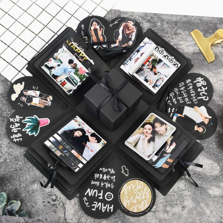 a table topped with black boxes covered in pictures