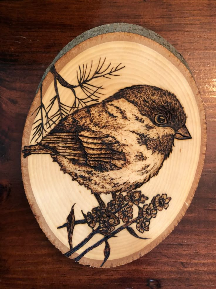 a wooden plate with a bird painted on it