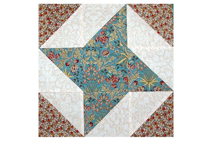 a blue and white star quilted on top of a table