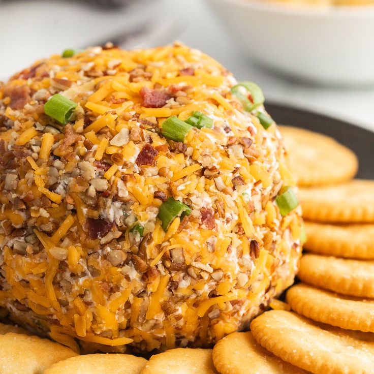 a cheese ball is sitting on top of crackers