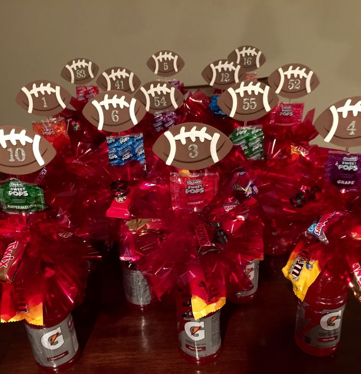 a table topped with red pom poms and football decorations