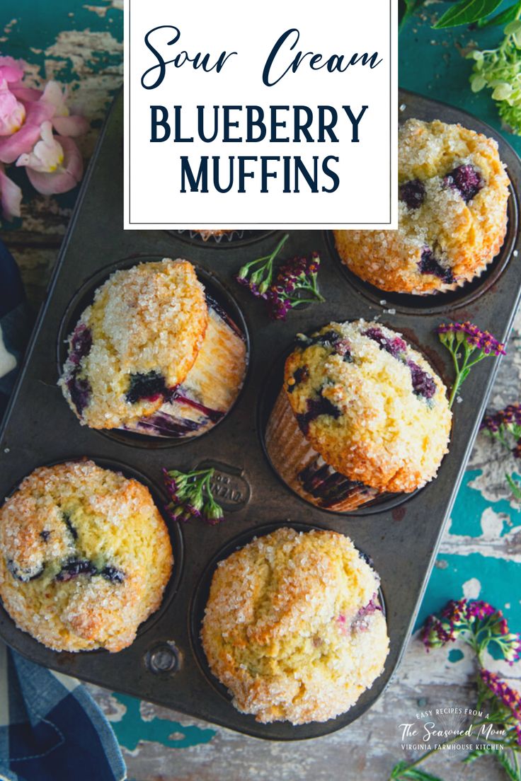 blueberry muffins in a muffin tin with the title, sour cream blueberry muffins