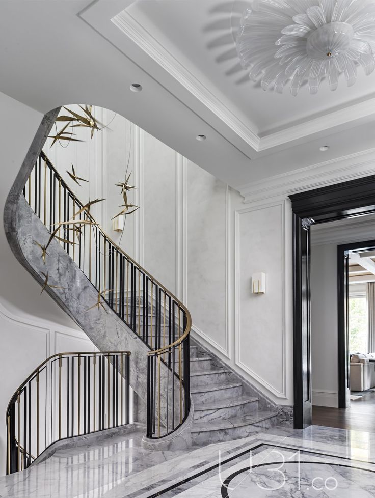 an elegant staircase with marble floors and white walls