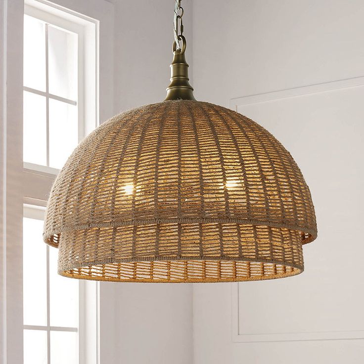 a light fixture hanging from a ceiling in a room with white walls and wooden flooring