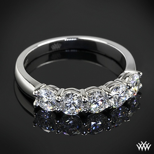 three stone diamond ring on black background