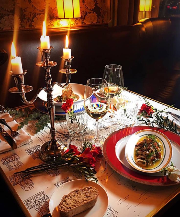 a table set for christmas dinner with candles