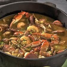 a pan filled with seafood and vegetables on top of a stove