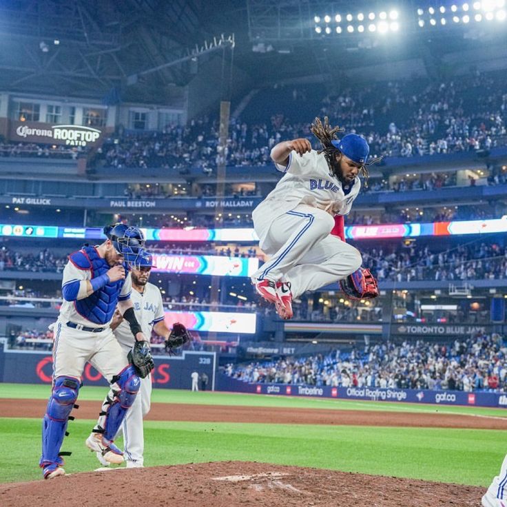 a baseball player is in mid air after throwing the ball