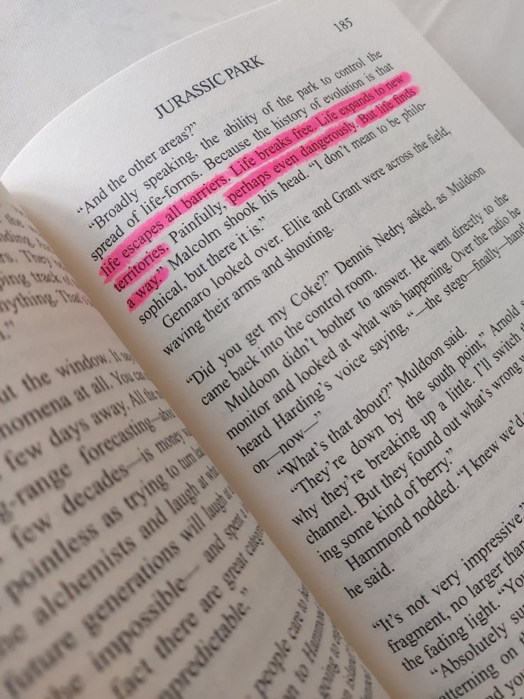 an open book with pink writing on it