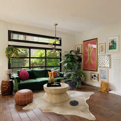 a living room filled with lots of furniture and decor on top of hard wood flooring