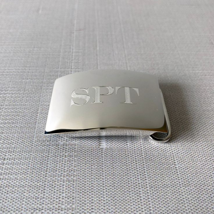 This sterling silver slide-style belt buckle features a plain polished finish. This buckle accommodates belt straps that measure 1-1/8″ (30 mm) in width. Buckles and belt straps are sold separately. Material: Sterling Silver Dimensions: 2″ x 1.375″ Luxury Silver Belt Buckles With Logo Plaque, Luxury Silver Belt Buckles For Business, Classic Formal Belt With Silver Buckle, Formal Engraved Belt Buckles, Classic Engraved Belts For Formal Occasions, Classic Formal Belts With Engraved Details, Classic Formal Belt With Engraved Details, Classic Formal Engraved Belt, Elegant Polished Belt Buckles For Formal Occasions