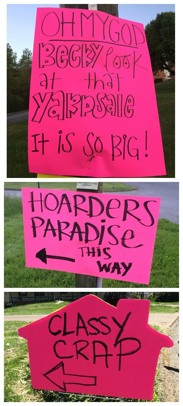 two pink signs with writing on them in different directions, one has an arrow and the other is a house