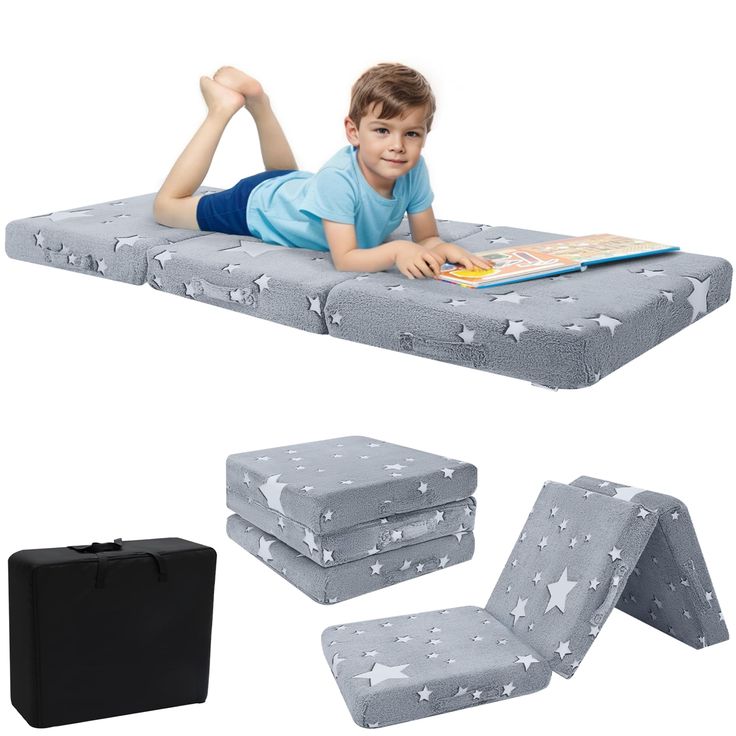 a young boy laying on top of a mattress