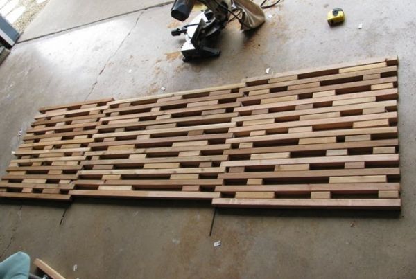 a motorcycle is parked next to a wooden panel on the floor in front of a wall