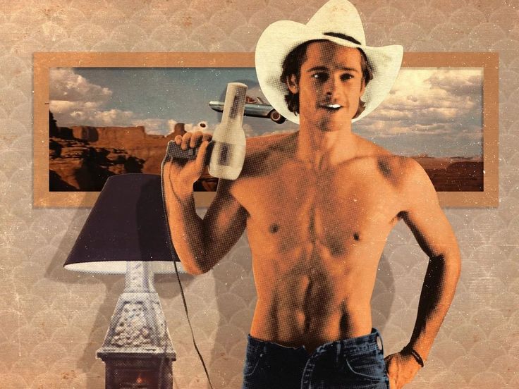 a shirtless man holding a remote control in his right hand and wearing a cowboy hat