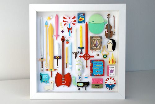 a shadow box filled with lots of different types of items in it's white frame