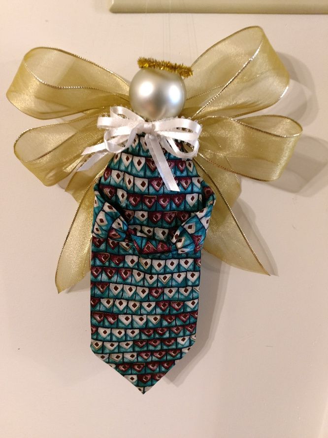 an ornament hanging from the side of a door with a tie on it