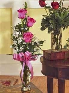 two vases filled with roses on top of a table