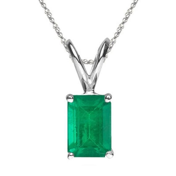 Natural Emerald Cut AA Quality Emerald Solitaire Pendant in 14K Gold Available in 5x3MM-8x6MM Pendant Information Metal:14K Gold Actual Metal:14K White Gold Rhodium:Yes Product Type:Solitaire Pendant Gender:Womens Material:Gemstone Chain Information Metal:14K Gold Actual Metal:14K White Gold Chain:Singapore Chain Length:18 in Clasp:Spring Ring Clasp Gemstone Information Gemstone:Natural Emerald Shape:Emerald Average Color:Medium Green Average Quality:AA Gemstone Dimensions:5x3 mm - 8x6 mm Settin Classic 14k Gold Necklace With Emerald Cut, Fine Jewelry Green Diamond Cut Necklaces, Classic Green Gemstone Necklace, Formal Diamond Cut Necklace For May Birthstone, Classic Emerald Pendant Necklace With Prong Setting, Classic Diamond Cut Emerald Pendant Necklace, Classic Emerald Diamond Cut Pendant Necklace, Green Diamond-cut 14k Gold Necklace, Classic Emerald Pendant Necklace With Diamond Cut