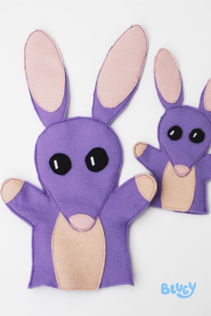 two purple rabbits with black eyes and one is holding the other's arm out