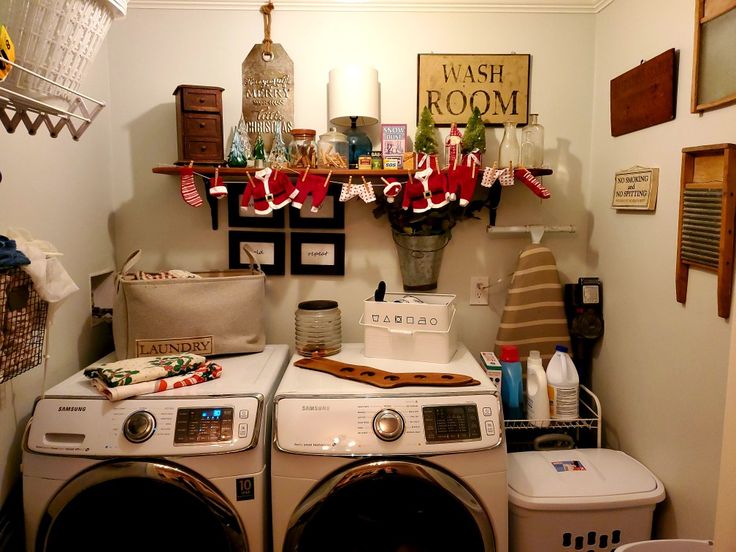 a washer and dryer in a small room with christmas decorations on the wall