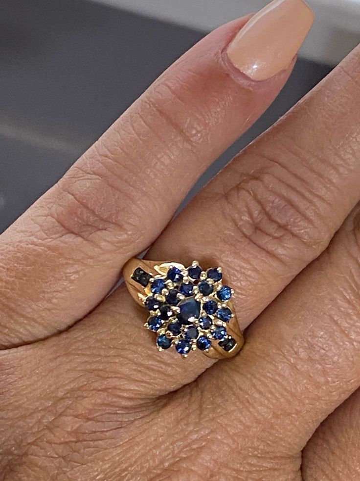 GORGEOUS Vintage 14K Yellow Gold .87 CTW Sapphire Cluster Ring Stunning estate ring with amazing hue blue sapphires! Ring has a .15 ct pear cut Sapphire center stone surrounded by 24 round .03 ct sapphires. .87 CTW! Size 6 Weighs 3.6 grams Please message me with any questions Shipped insured/delivery confirmation I guarantee item to be exactly as described and pictured Ruby Heart Pendant, Sapphire Cluster Ring, Black Opal Pendant, Locket Ring, Estate Ring, Estate Rings, Heart Pendant Diamond, Initial Ring, Blue Sapphire Rings