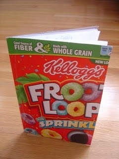 a box of fruit flavored cereal sitting on top of a wooden table