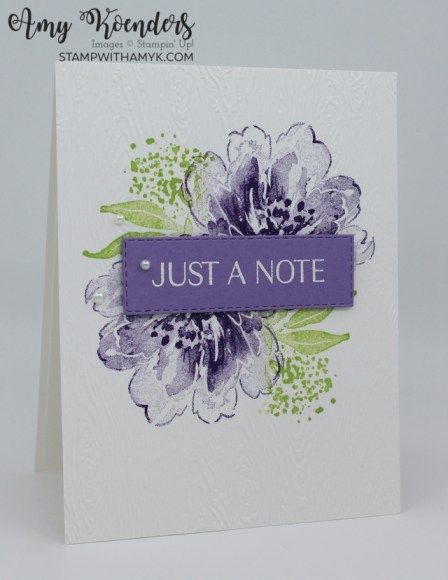 a white card with purple flowers and the words just a note written in blue on it